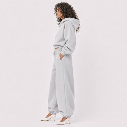 Side view of oversized light grey FineAF Magnetic pants with elastic ankles and matching hoodie
