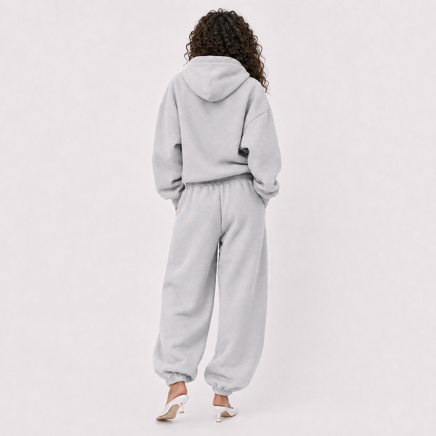 Back view of pocket-free oversized light grey FineAF Magnetic pants with matching hoodie