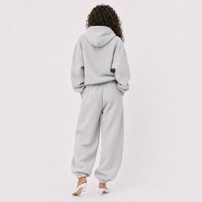 Back view of pocket-free oversized light grey FineAF Magnetic pants with matching hoodie
