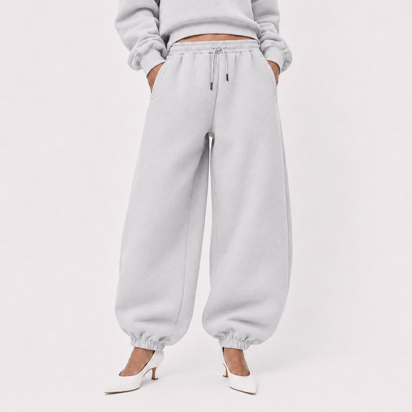 Waist-to-shoe fit view of oversized light grey FineAF Magnetic pants with drawcord and elastic ankles