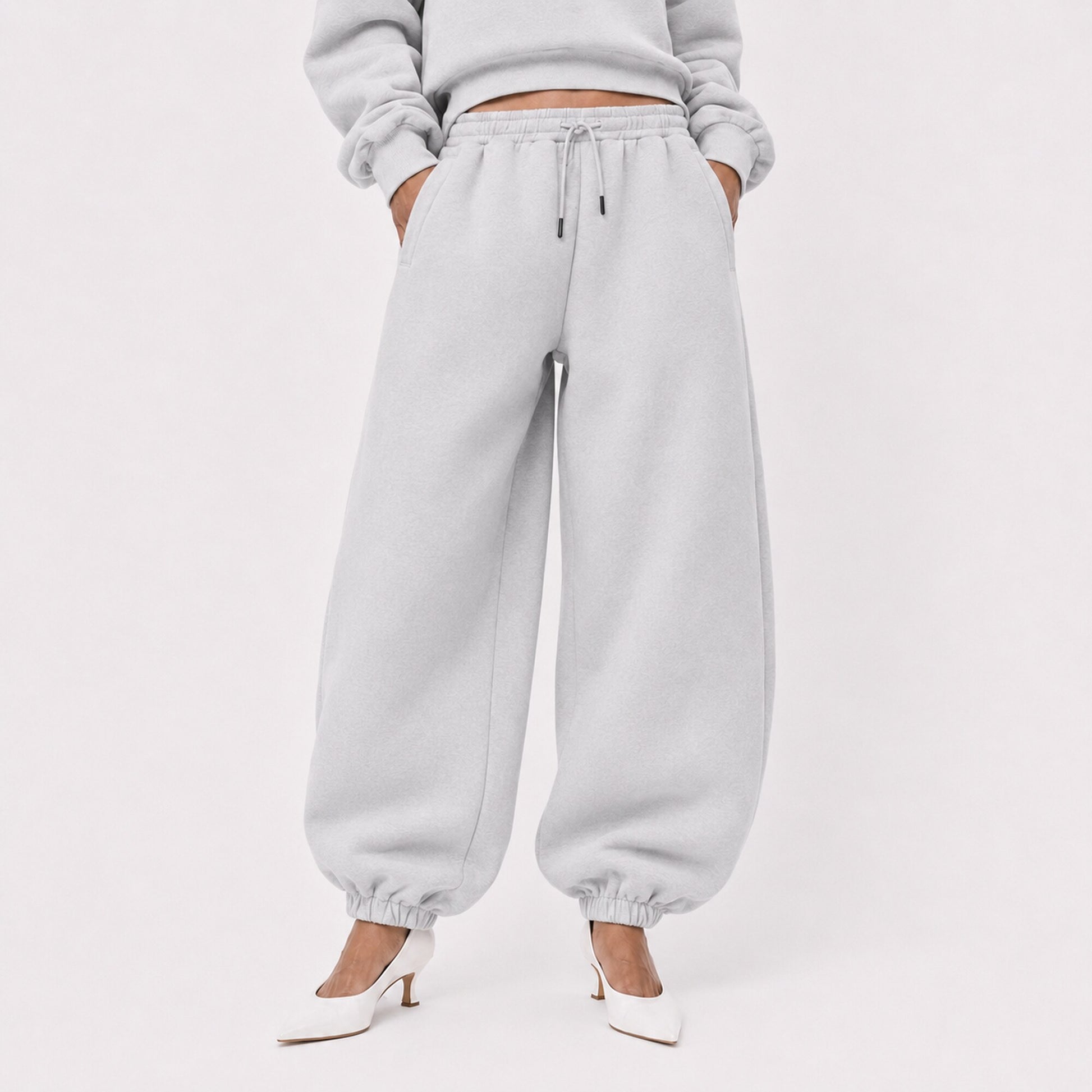 Waist-to-shoe fit view of oversized light grey FineAF Magnetic pants with drawcord and elastic ankles