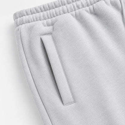Close-up of the slanted welt pocket and gathered waistband on light grey FineAF Magnetic pants