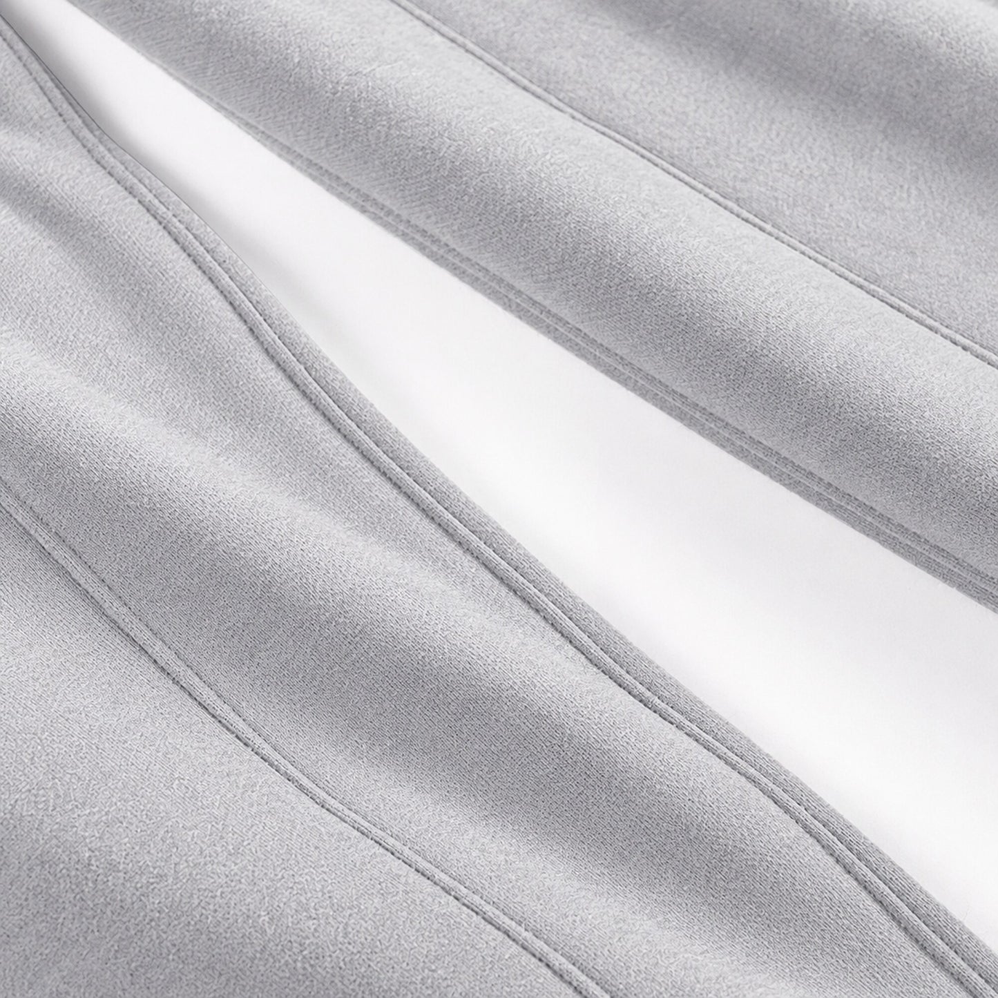Close-up of the long stitched seam construction on light grey FineAF Magnetic pants