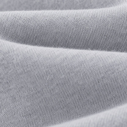 Macro view of the soft light grey knit surface of FineAF Magnetic pants
