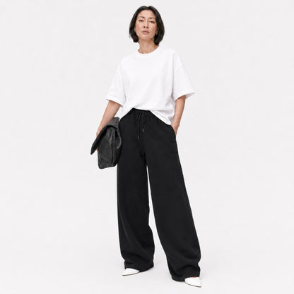 White FineAF Boxy Tee styled with black wide-leg pants, full-length editorial view