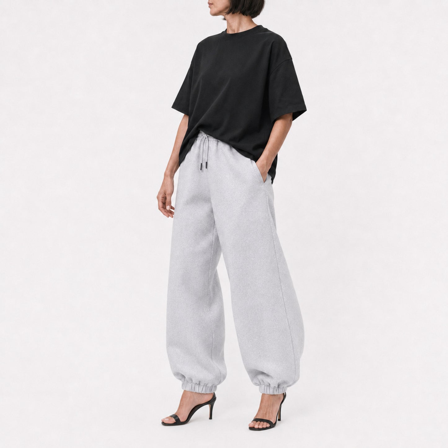 Black FineAF Boxy Tee styled with grey joggers, full-length editorial view
