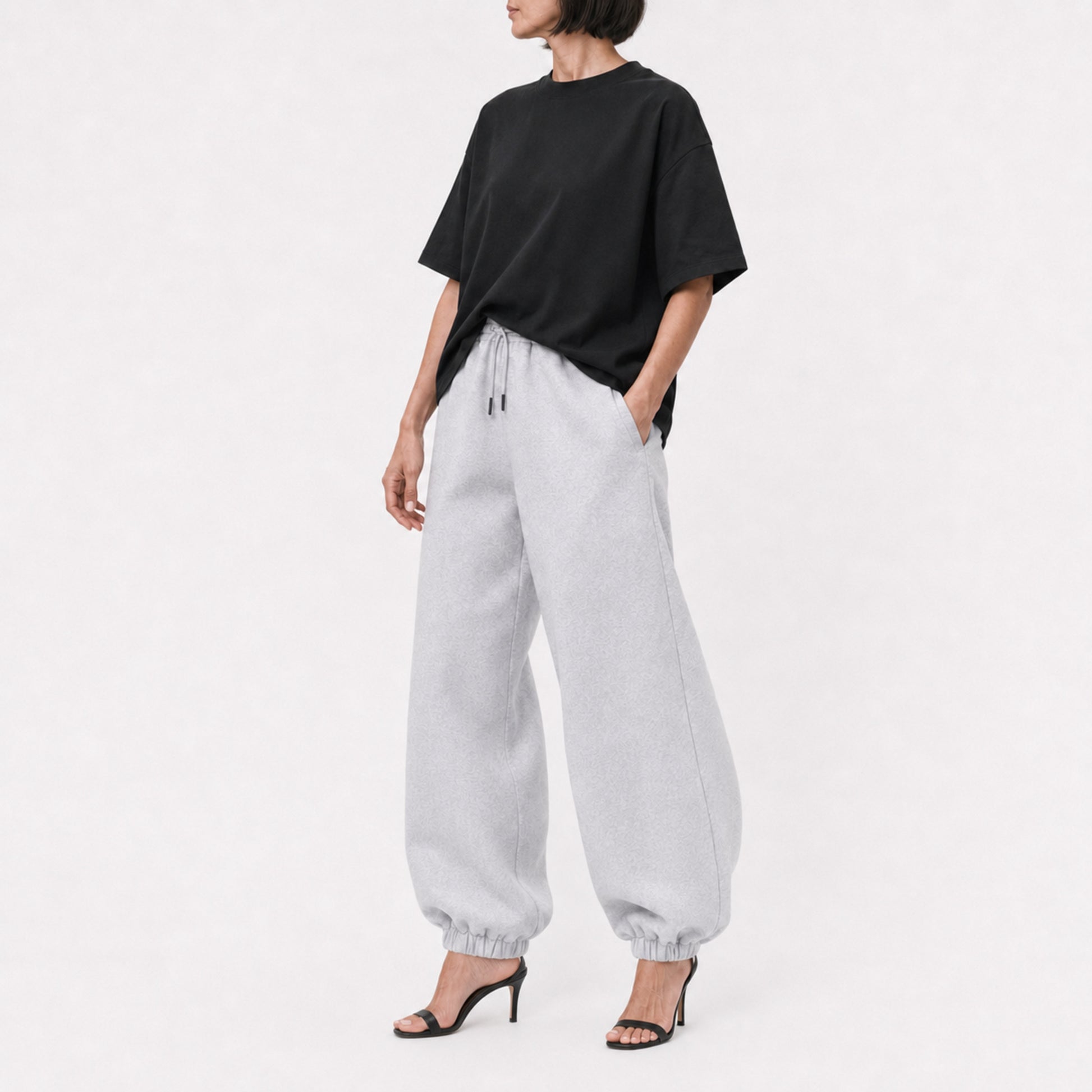 Black FineAF Boxy Tee styled with grey joggers, full-length editorial view