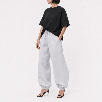 Black FineAF Boxy Tee styled with grey joggers, full-length editorial view