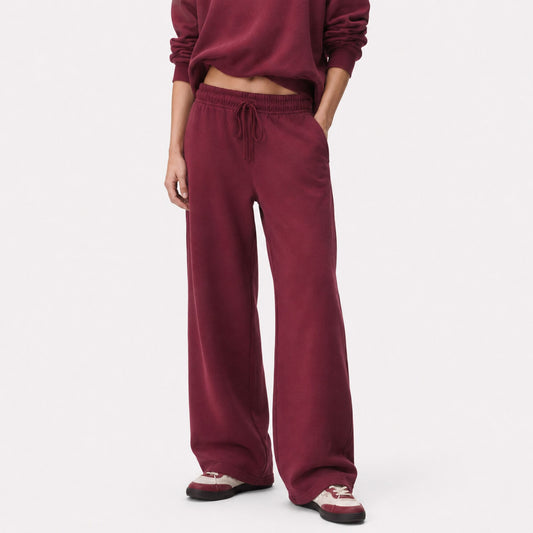 Front view of oversized FineAF Visionary straight-leg pants in deep wine with gathered drawstring waist and open hems.