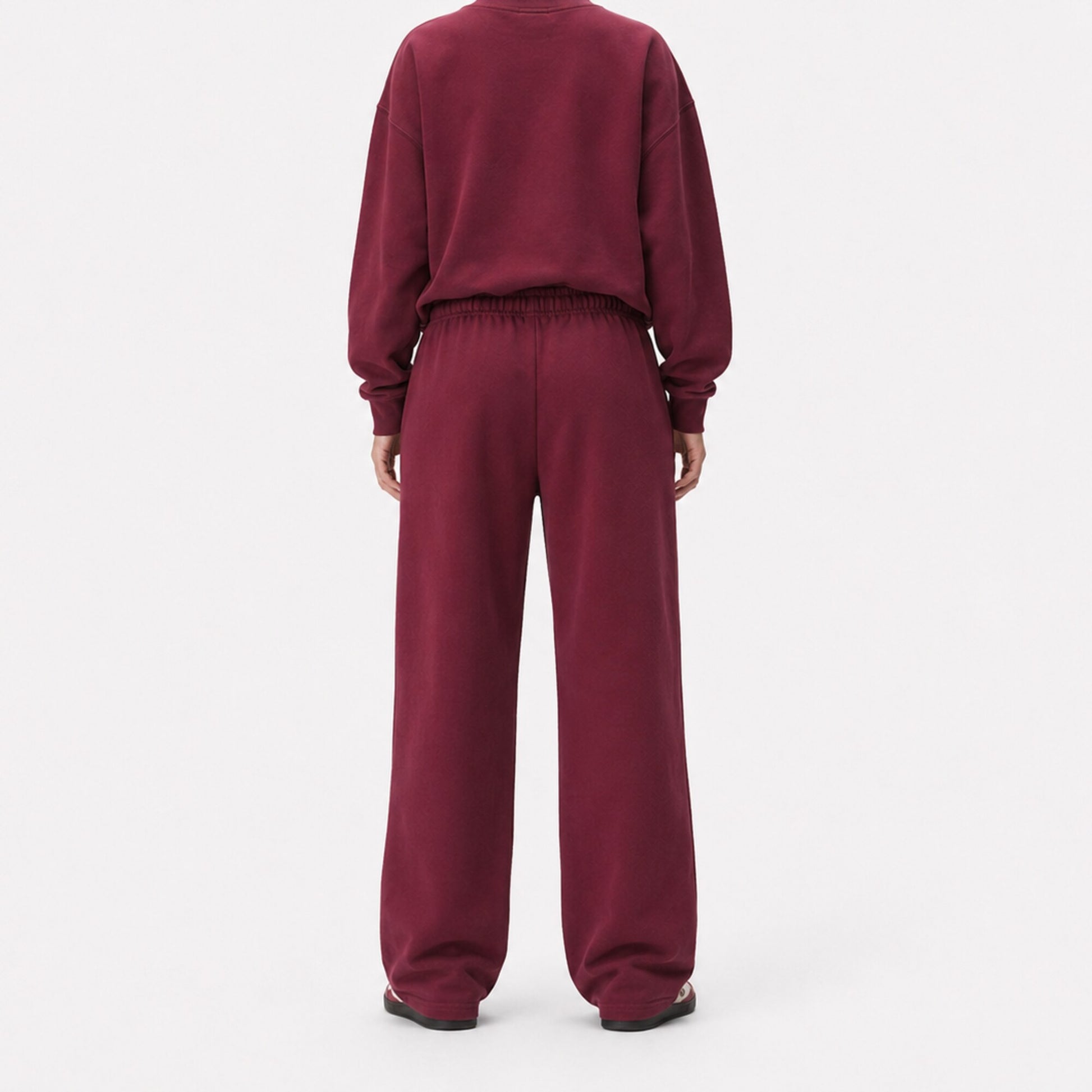 Back view of oversized FineAF Visionary wine pants showing the clean seat, gathered waistband and straight legs.