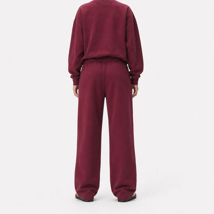Back view of oversized FineAF Visionary wine pants showing the clean seat, gathered waistband and straight legs.