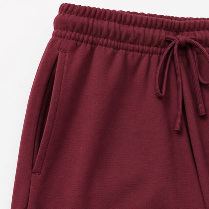 Close-up of the FineAF Visionary wine pant gathered waistband, tonal drawcord and slanted side pocket.