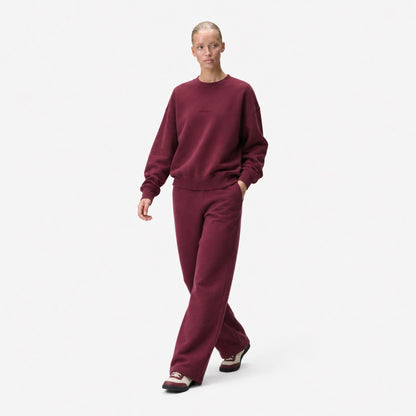 Woman walking in the FineAF Visionary wine sweatshirt and matching sweatpants set