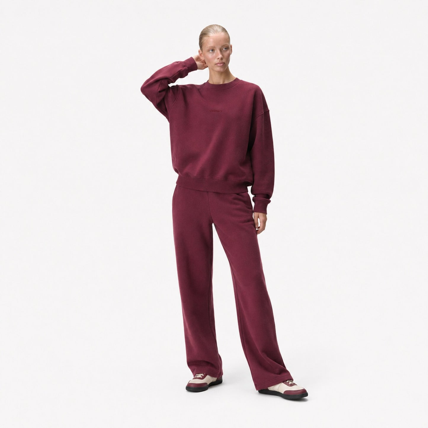 Woman in the FineAF Visionary wine sweatshirt showing its structured sleeves and relaxed oversized fit