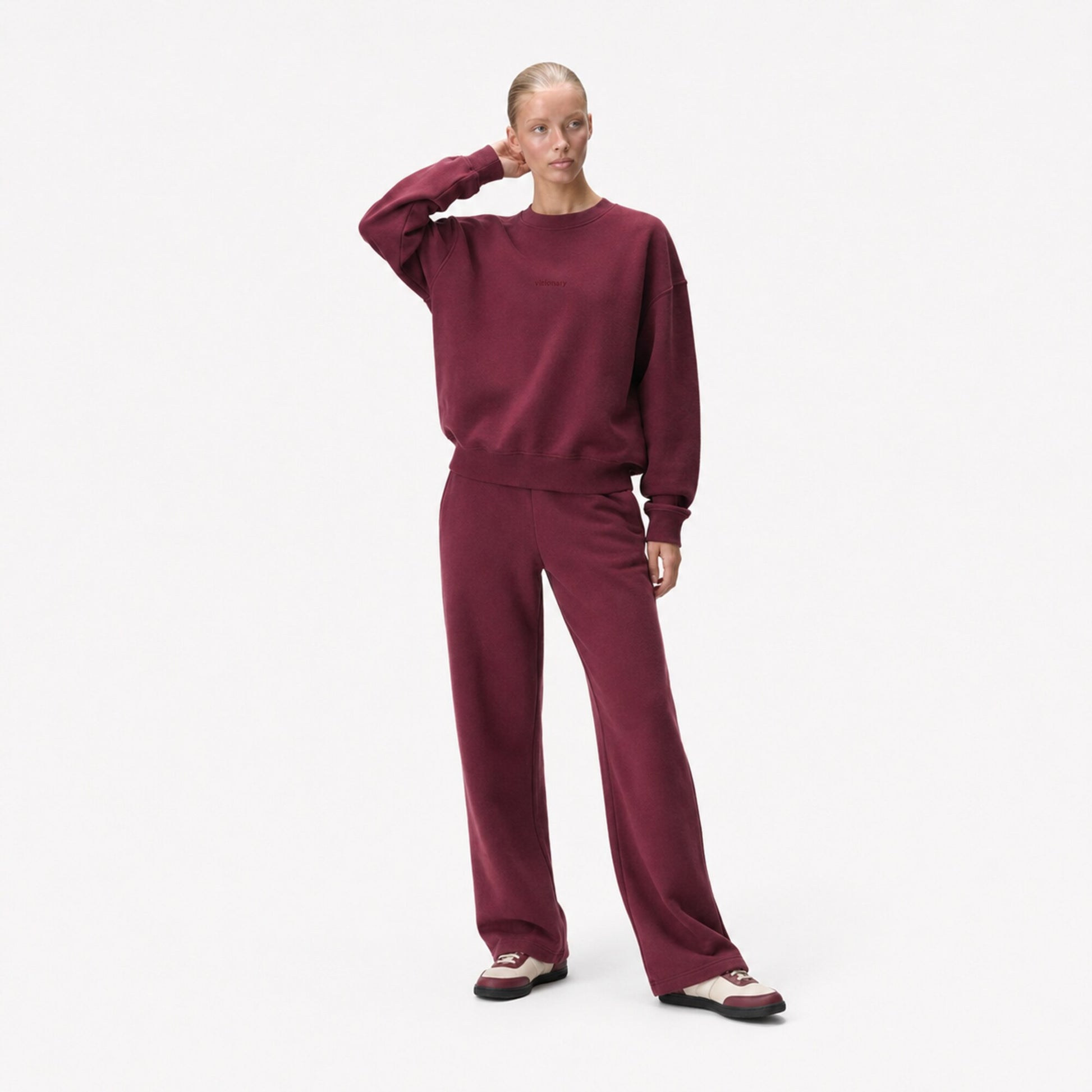 Woman in the FineAF Visionary wine sweatshirt showing its structured sleeves and relaxed oversized fit