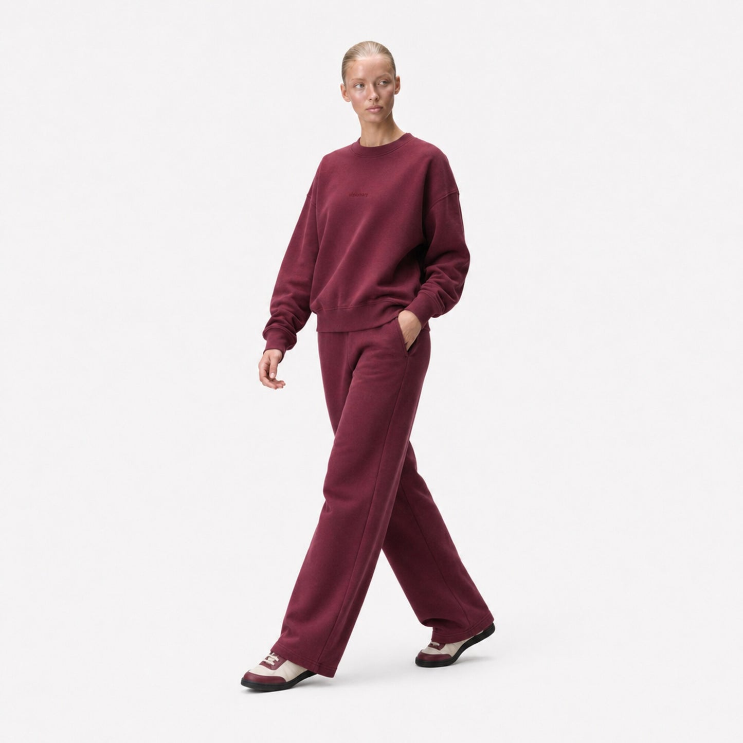 Three-quarter editorial view of the FineAF Visionary wine sweatshirt and matching sweatpants