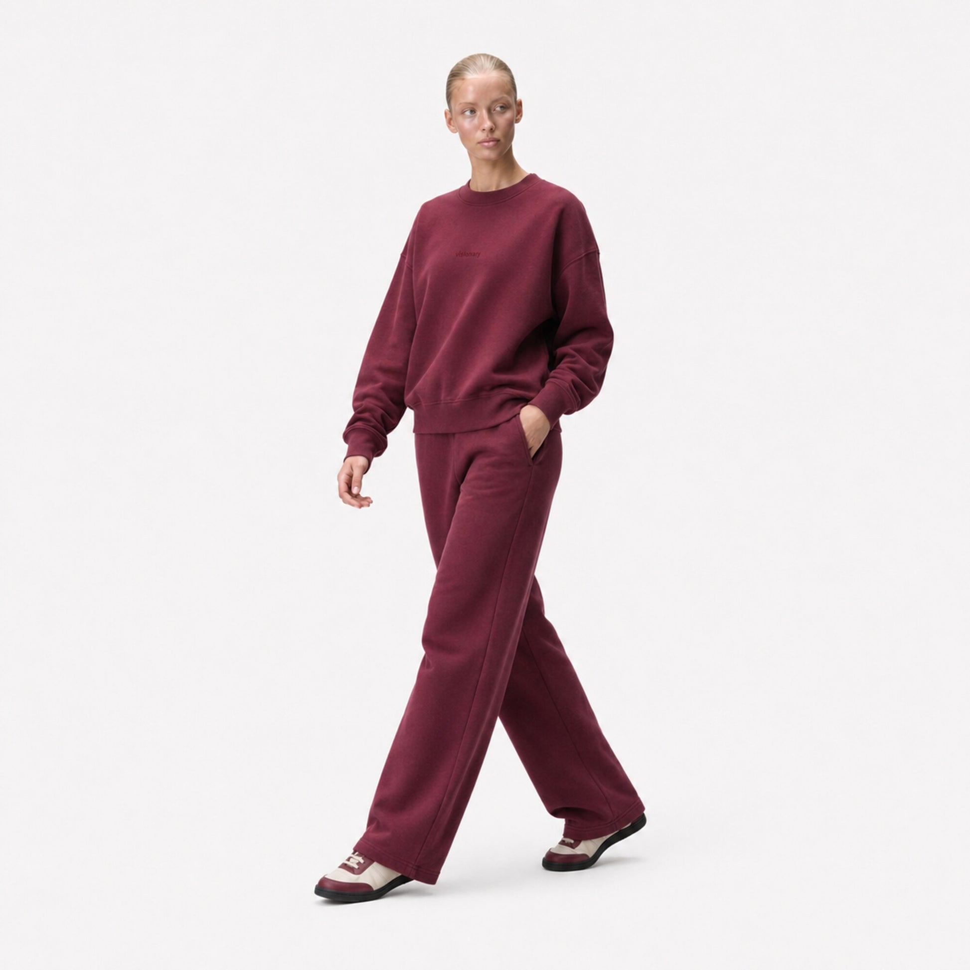 Three-quarter editorial view of the FineAF Visionary wine sweatshirt and matching sweatpants