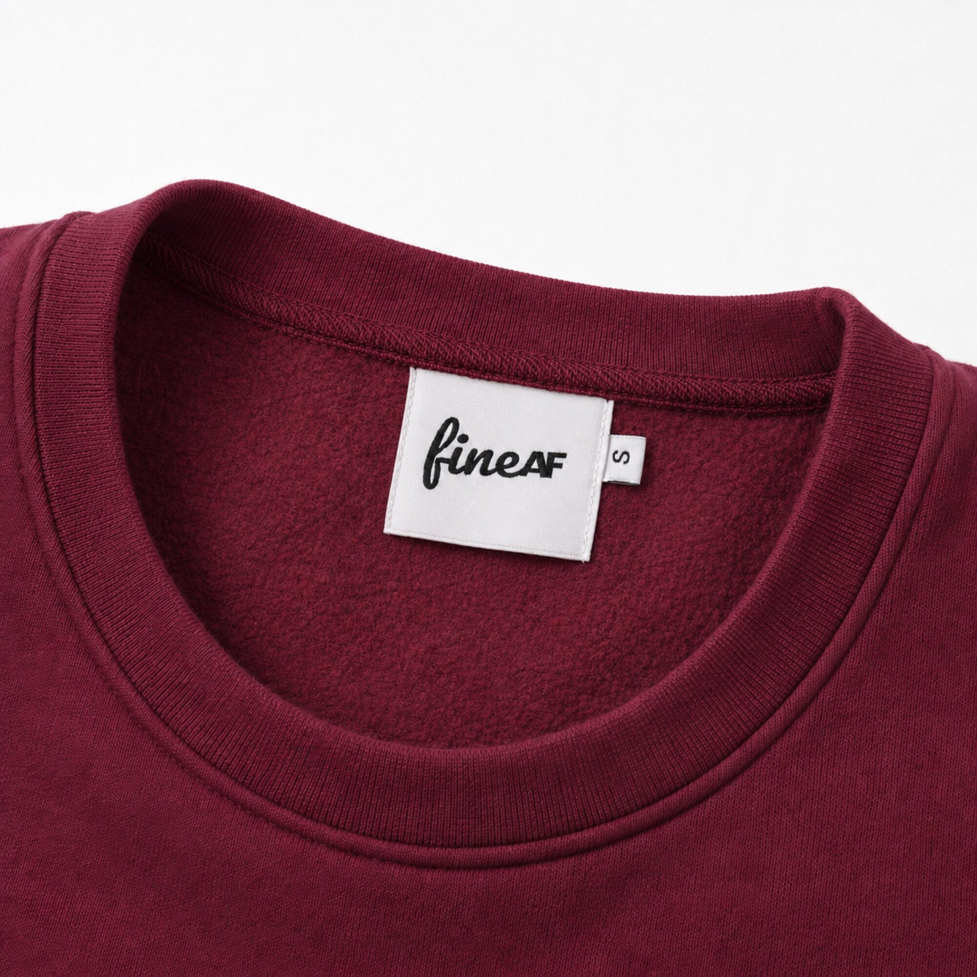 Close-up of the FineAF Visionary sweatshirt ribbed collar, brushed interior and FineAF neck label