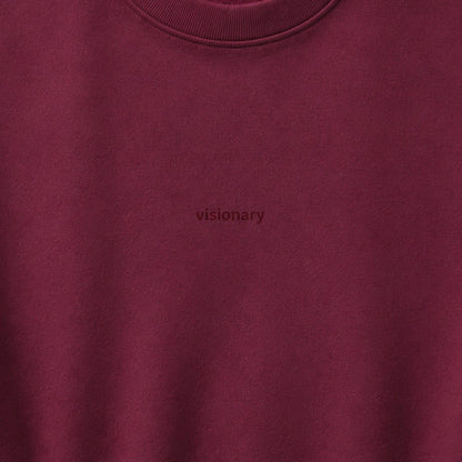 Close-up of the small tonal visionary chest design on wine fleece