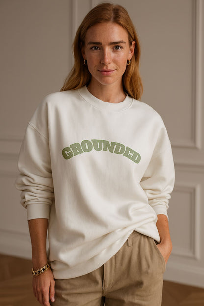 Model wearing FineAF GROUNDED Sweatshirt in bright white organic cotton, relaxed fit, natural daylight studio.